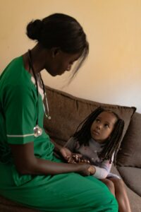 Parent checks a tired child’s breathing at home beside a thermometer and water cup.