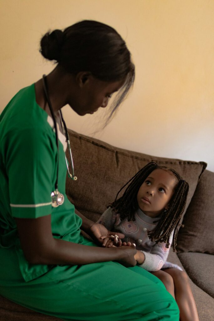 Parent checks a tired child’s breathing at home beside a thermometer and water cup.