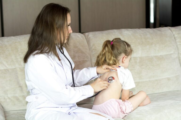 Parent checks a tired child’s breathing and hydration at home while holding a thermometer.